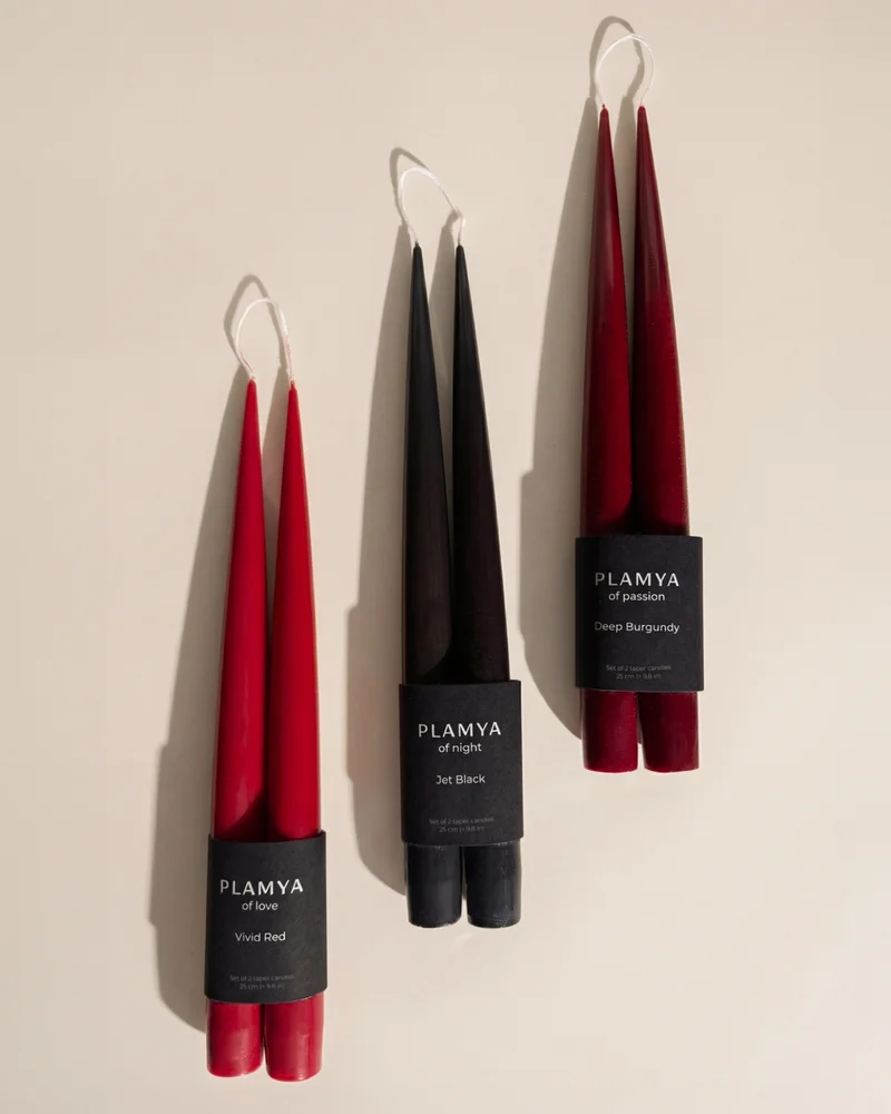 Sculptural candles with a clean, minimal silhouette displayed upright against a neutral background.