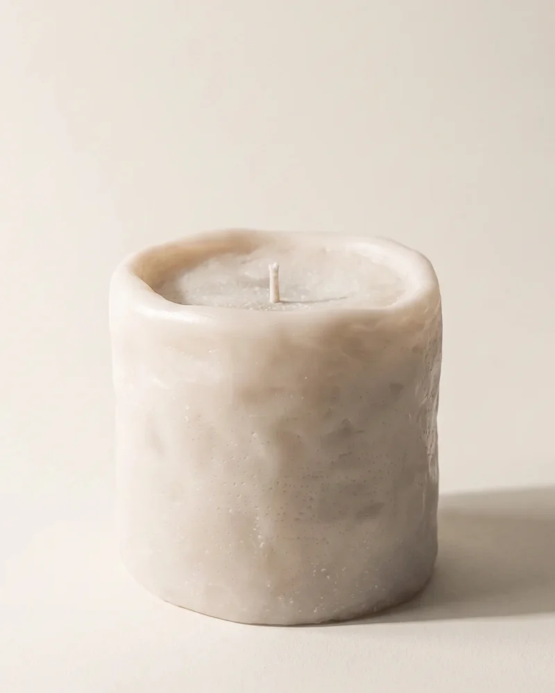 Light-coloured Clay Cylinder decorative candle with an uneven rim and textured surface