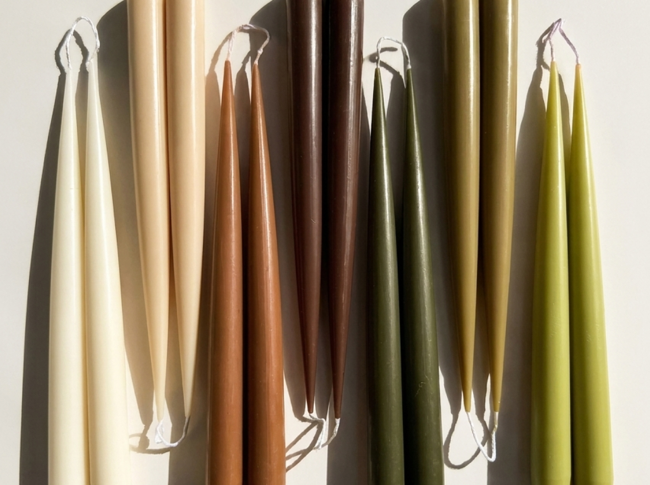 Sculptural candles standing upright with a smooth, contemporary form.