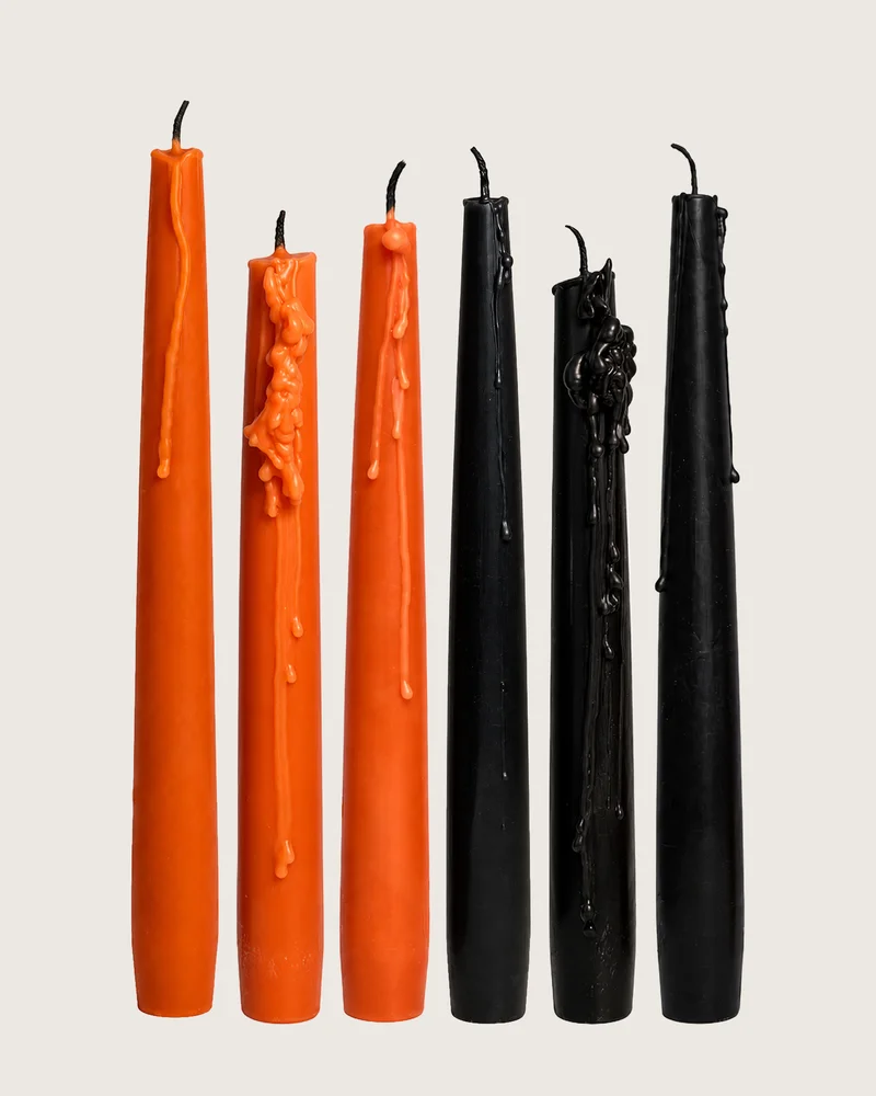 Sculptural candles standing upright with a smooth, matte surface.