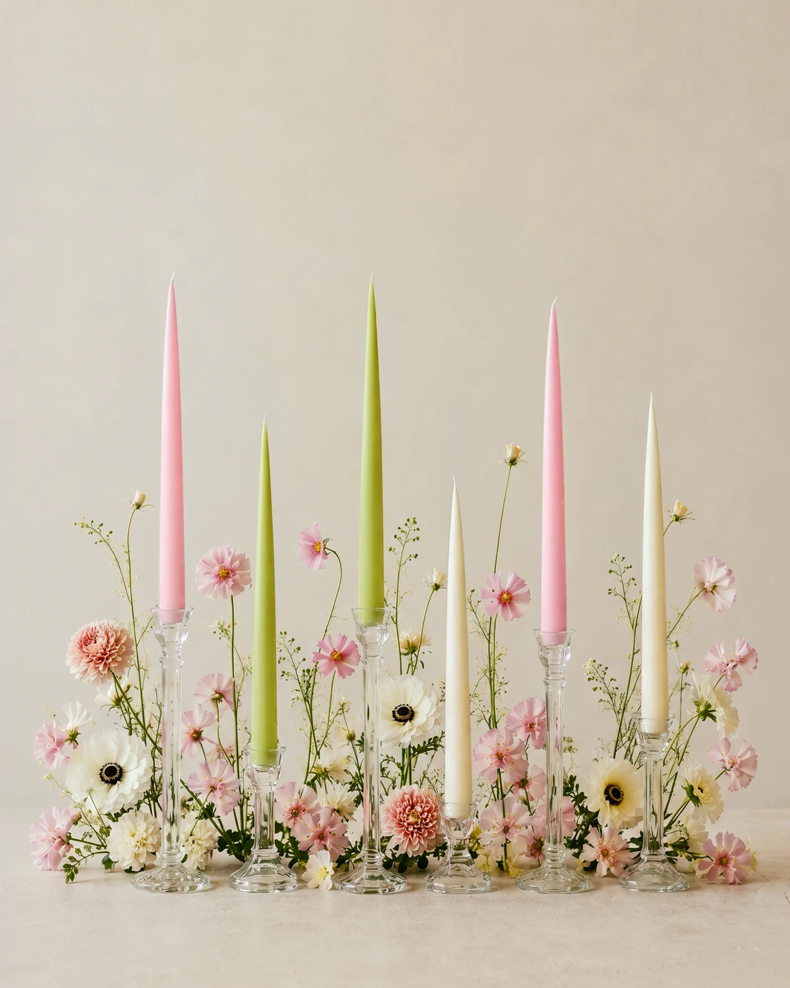 Bloom Six taper candles in clear holders among pink and white flowers