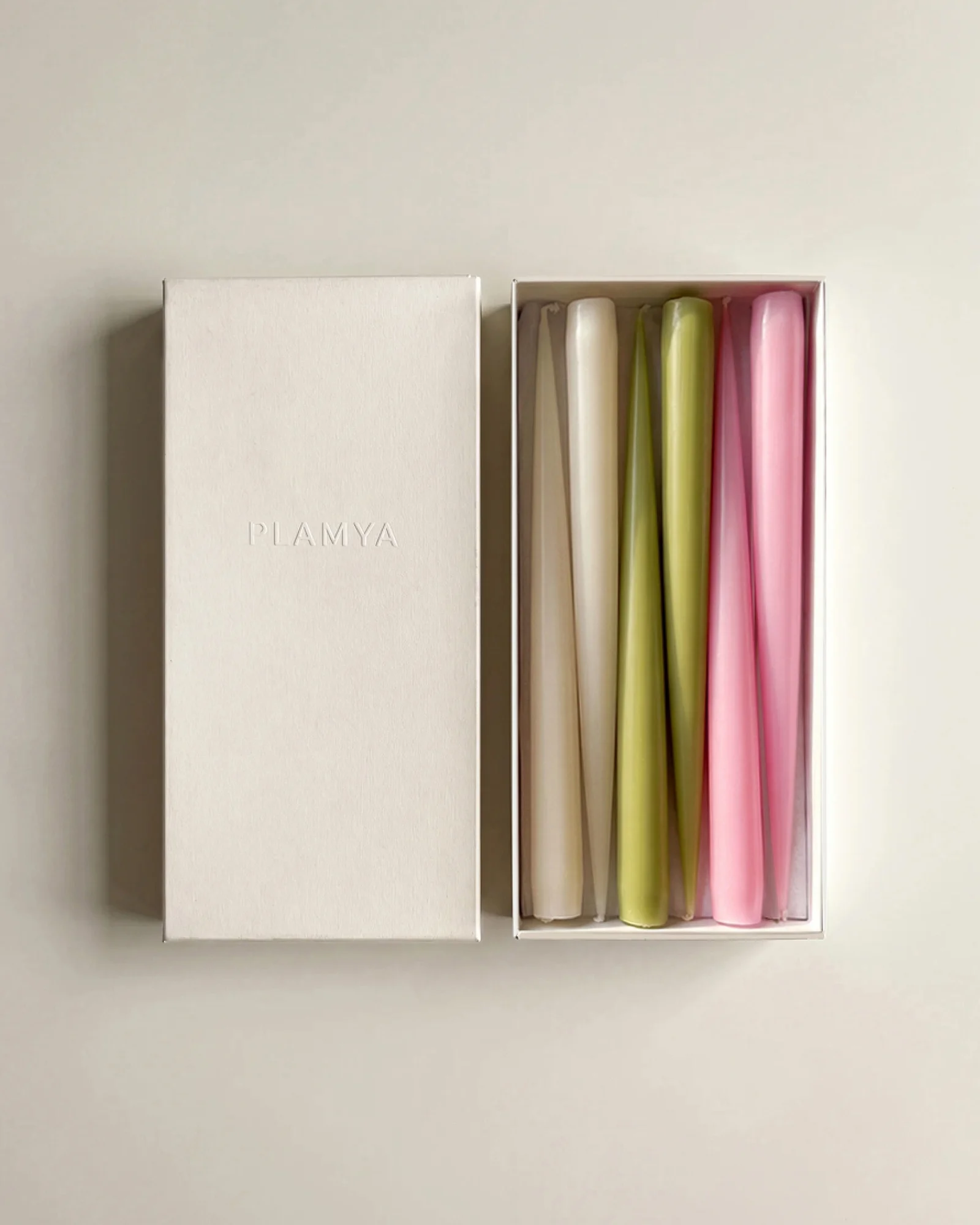 Open PLAMYA box containing the Bloom Six taper candles beside its lid