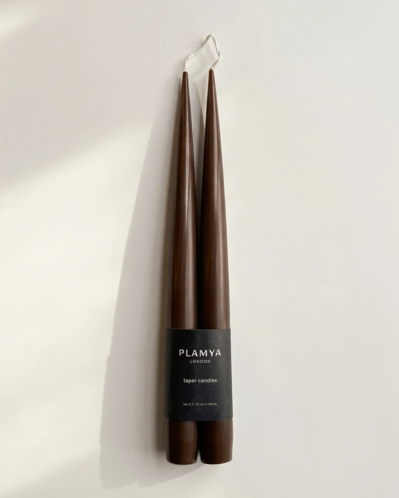 Pair of earth brown PLAMYA taper candles wrapped with a black paper band