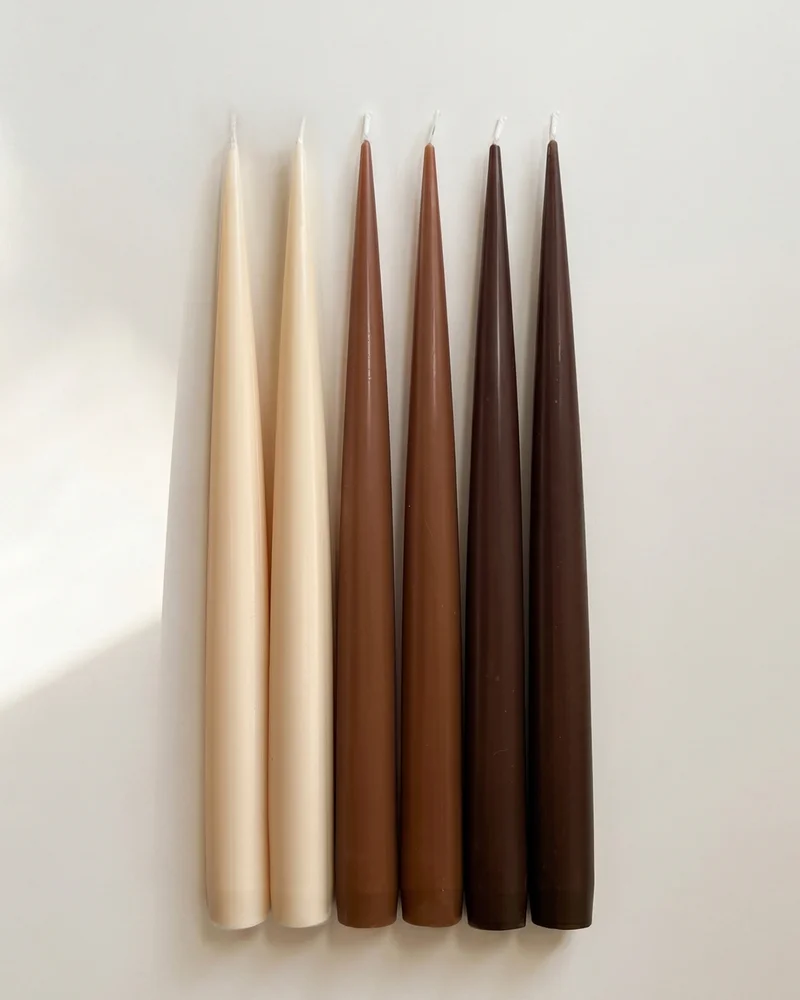 Earthen Six taper candles arranged in pairs of ivory, warm brown and dark brown