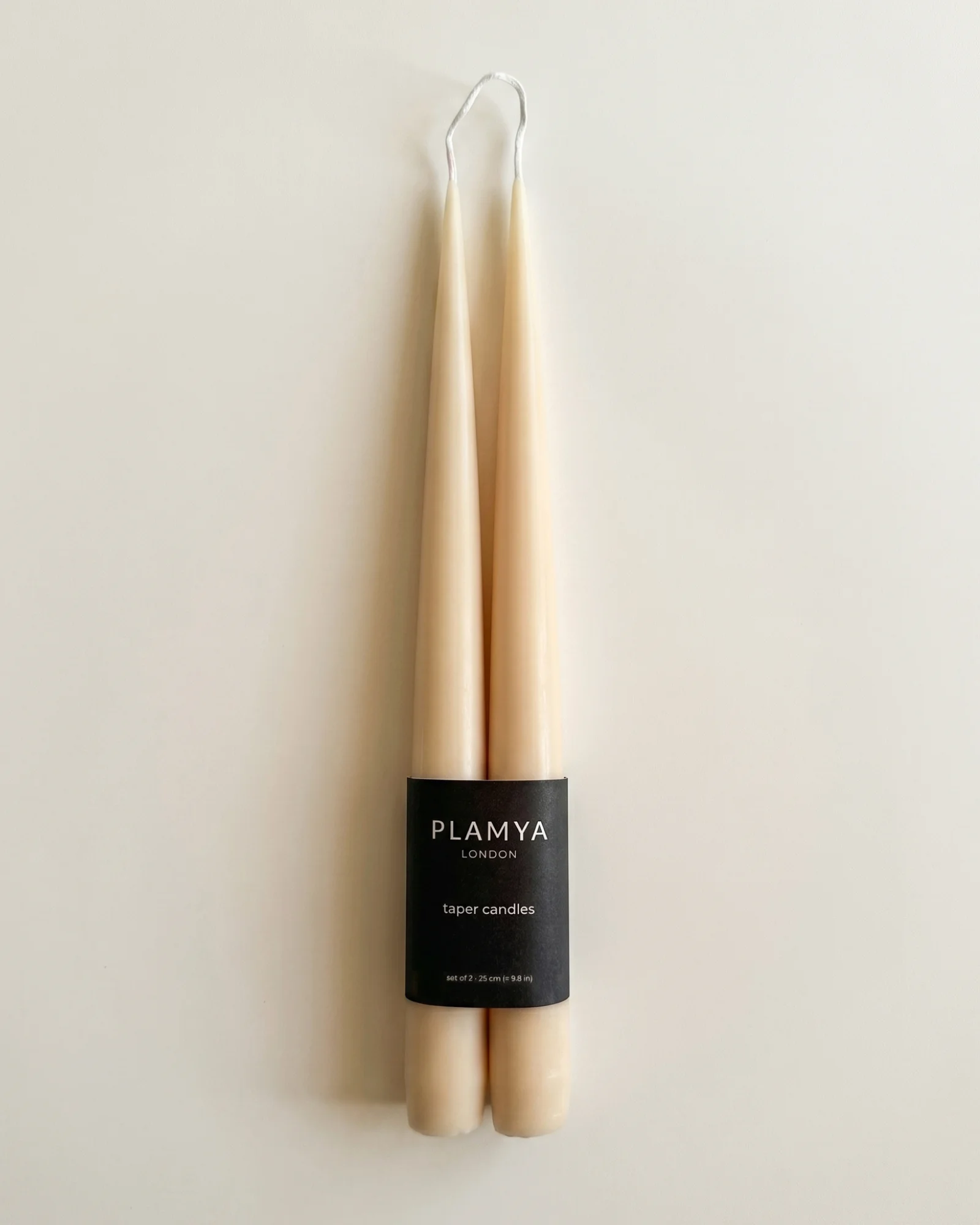 Ember taper candle pair wrapped with a black PLAMYA paper band