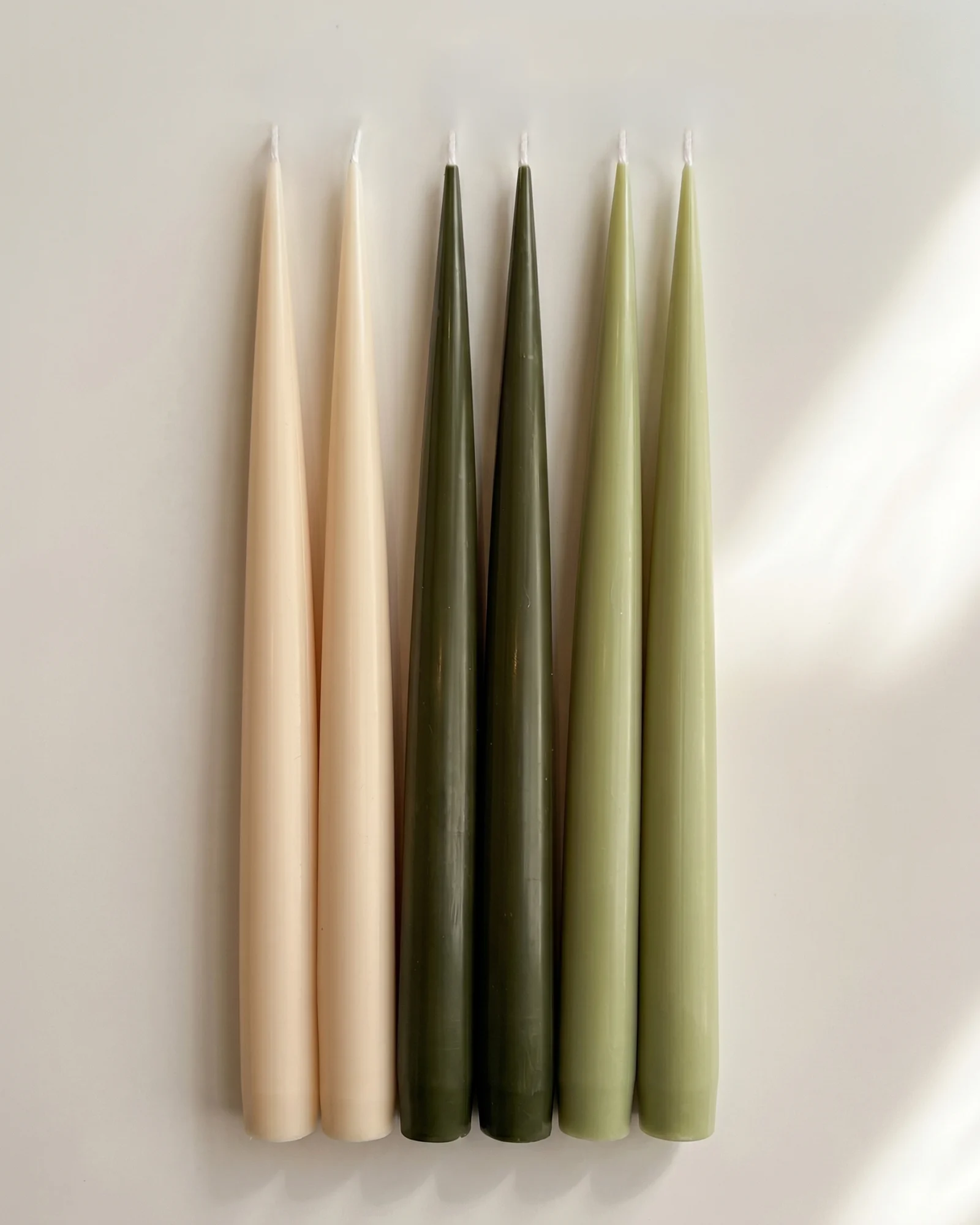 Forest Six taper candles arranged in pairs of ivory, deep green and pale green