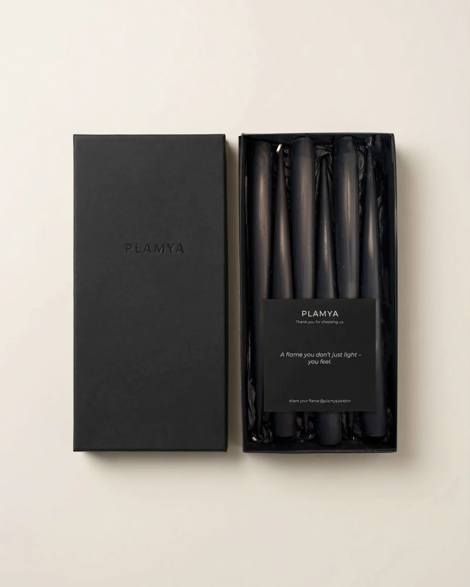 Open black PLAMYA box containing six Jet Black taper candles