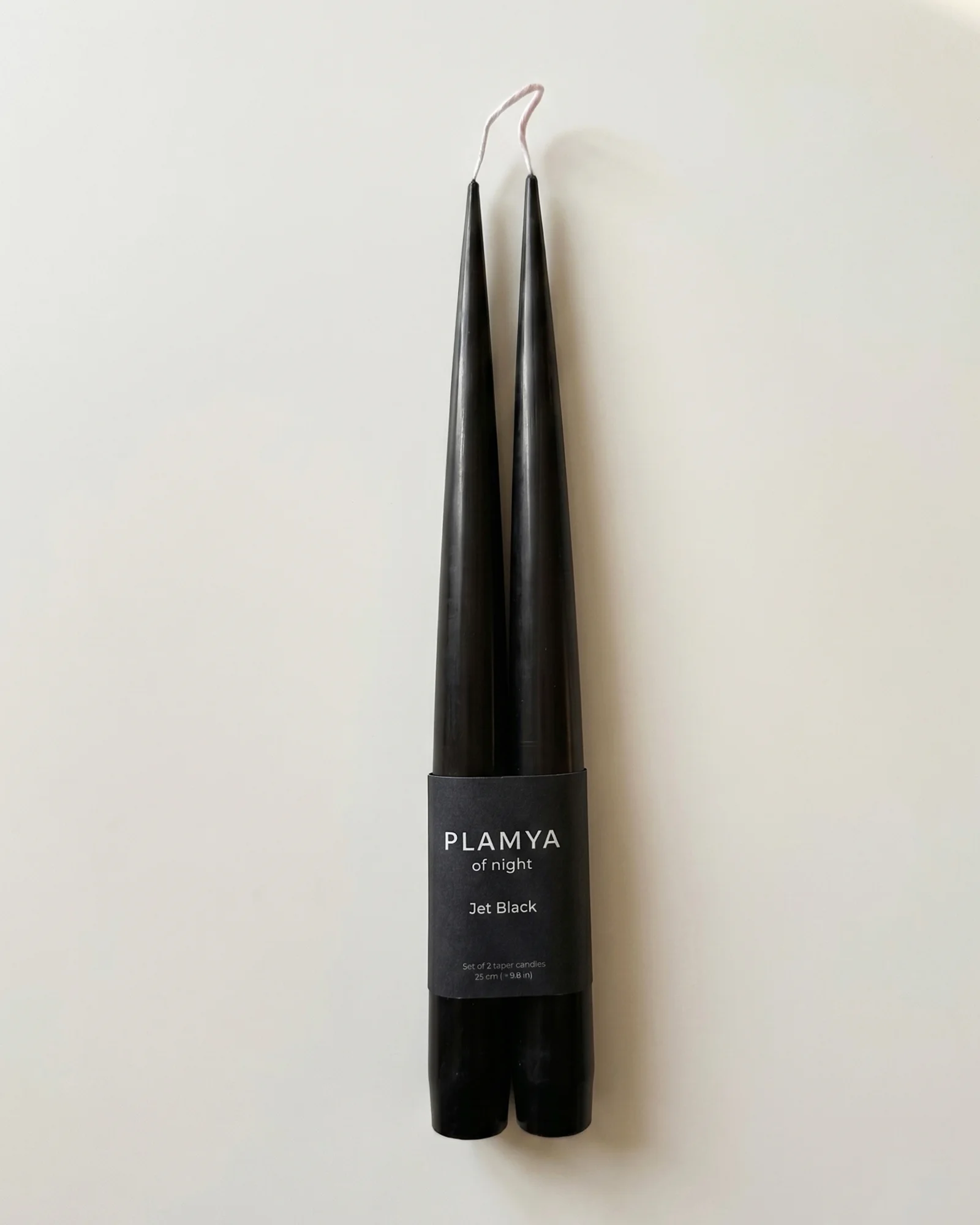 Jet Black taper candle pair wrapped with a PLAMYA paper band