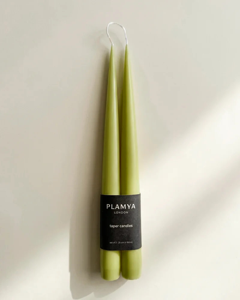 Matcha taper candle pair wrapped with a black PLAMYA paper band