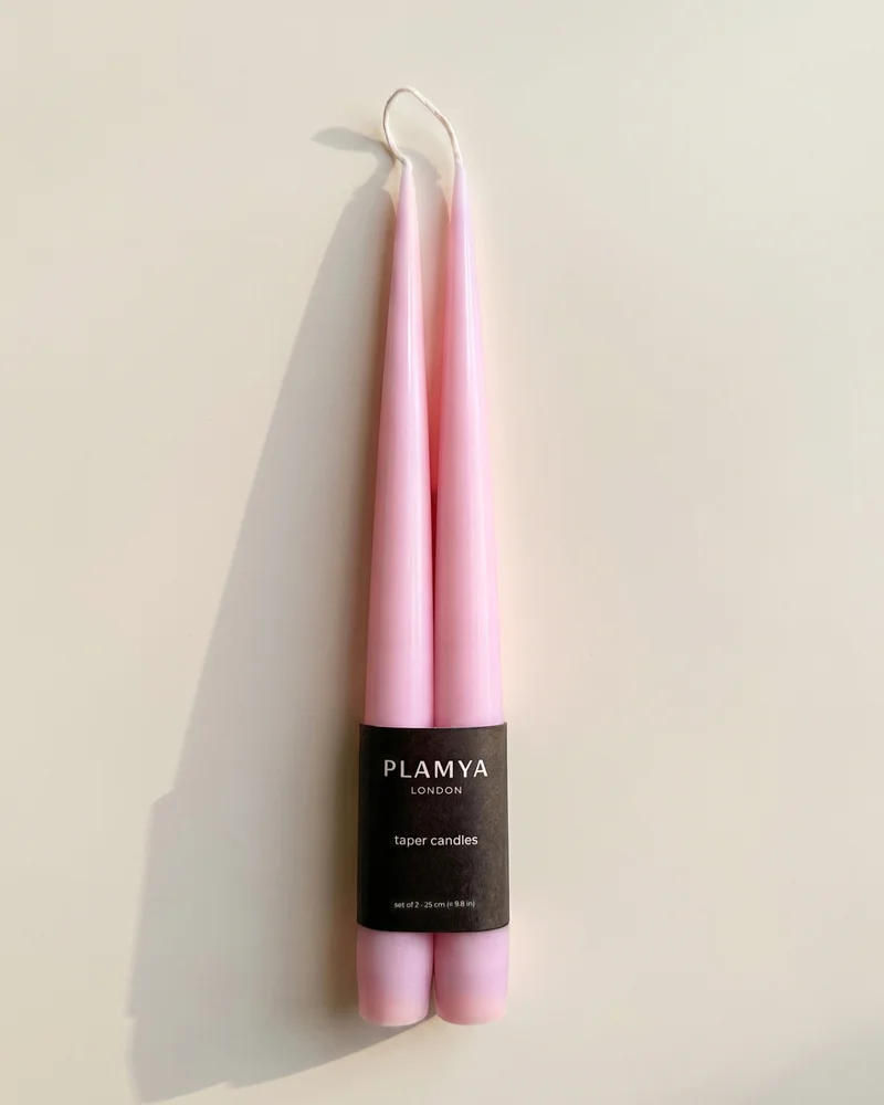 Rose taper candle pair wrapped with a black PLAMYA paper band