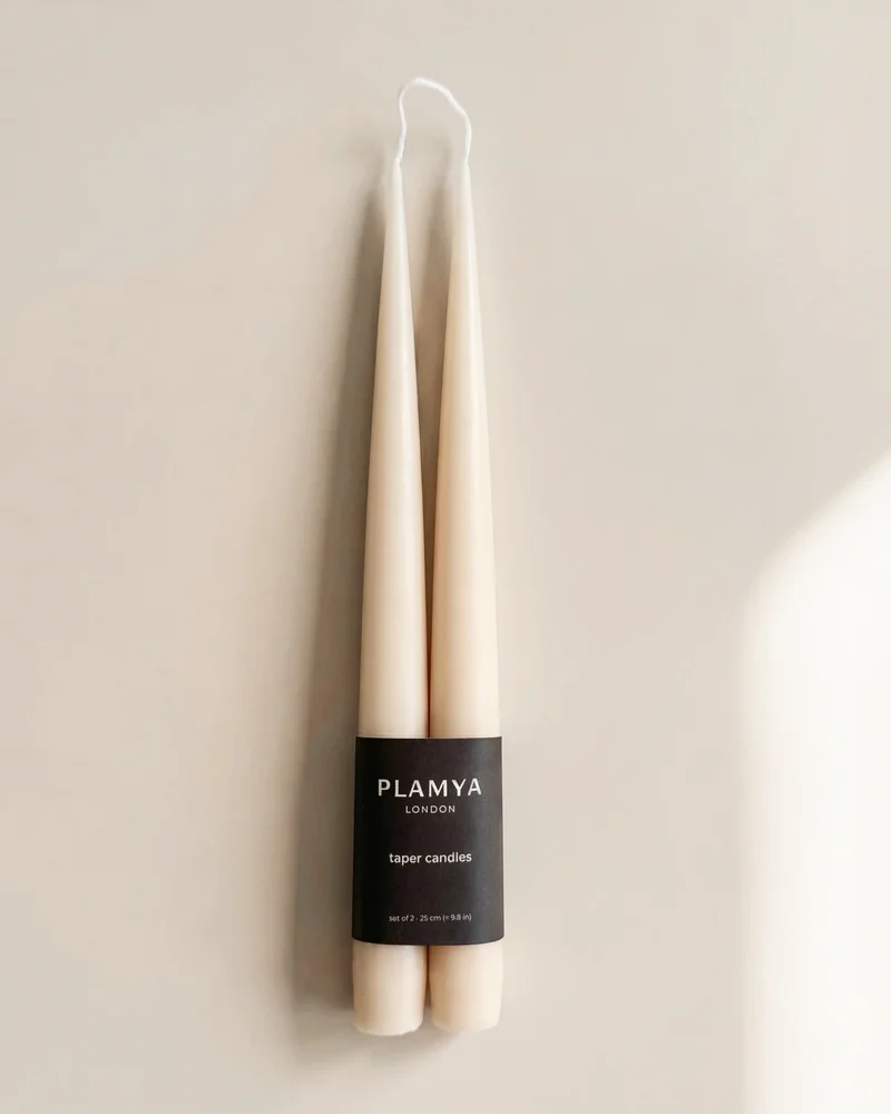 Soft Ivory taper candle pair wrapped with a black PLAMYA paper band