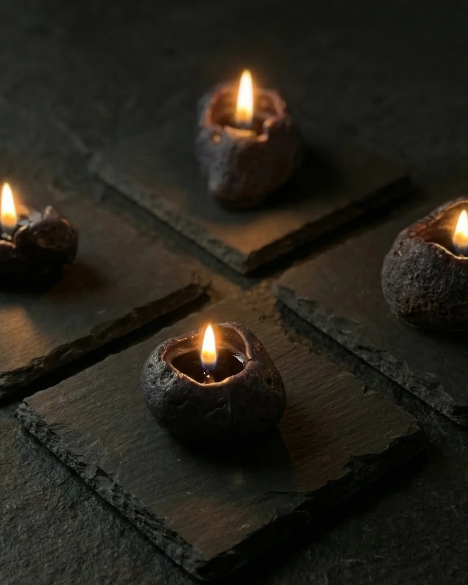 Sculptural candles standing upright with a smooth, minimal profile.