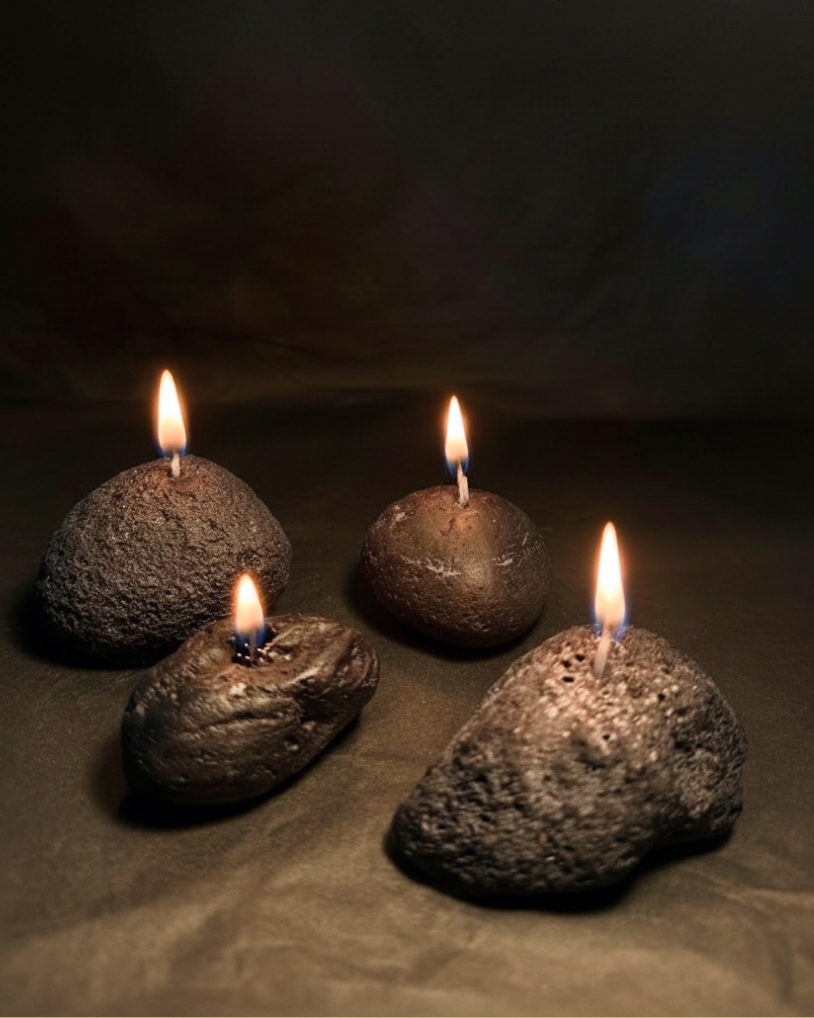 Sculptural candles standing upright with a smooth, column-like form.